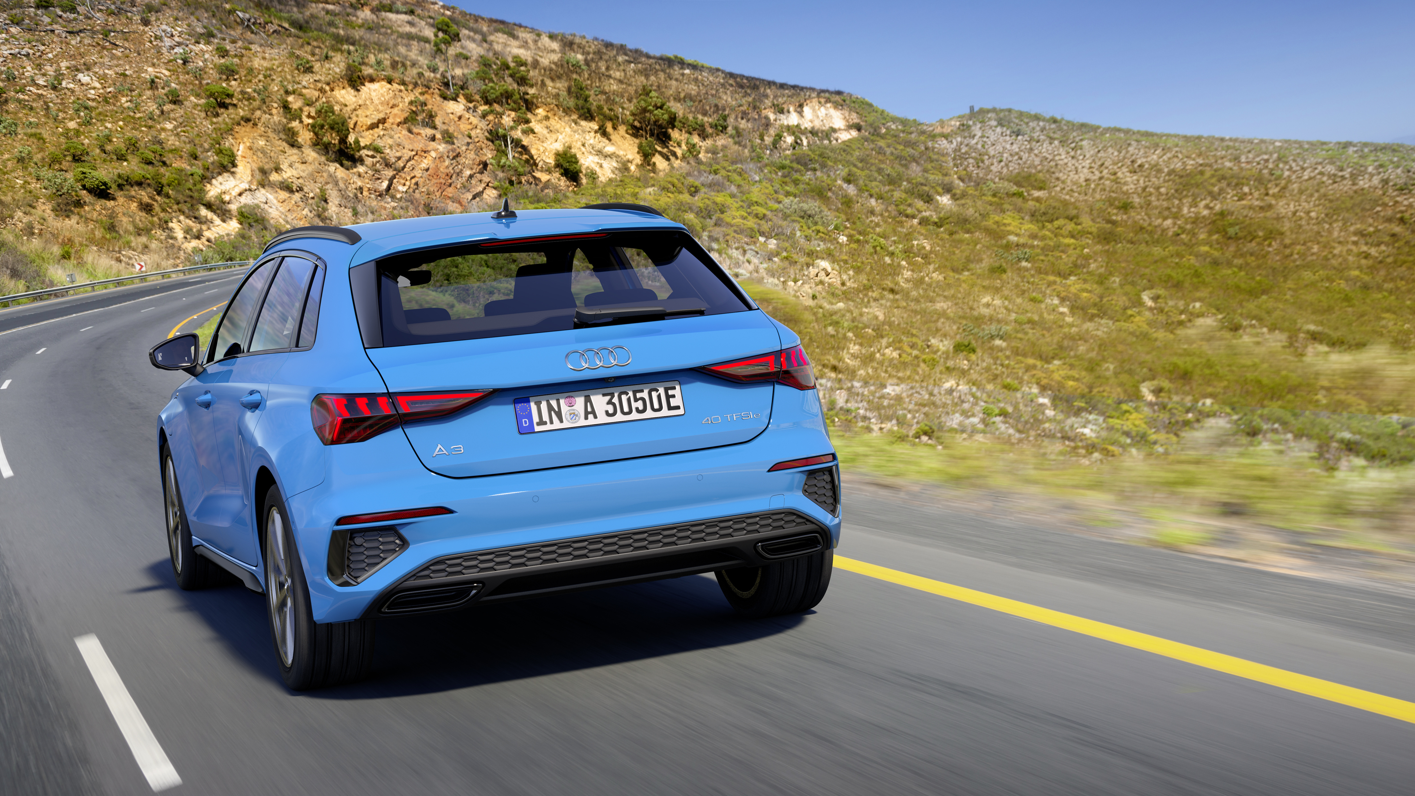 Rear view of a Audi A3 driving on a country road