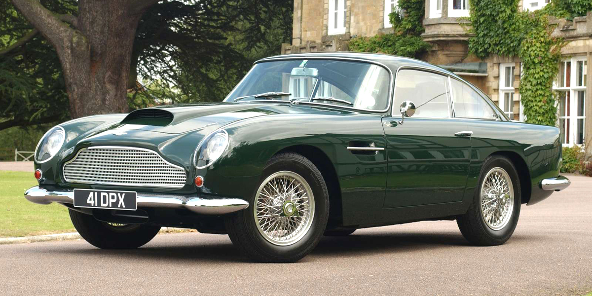 A dark green Aston Martin DB4 GT parked