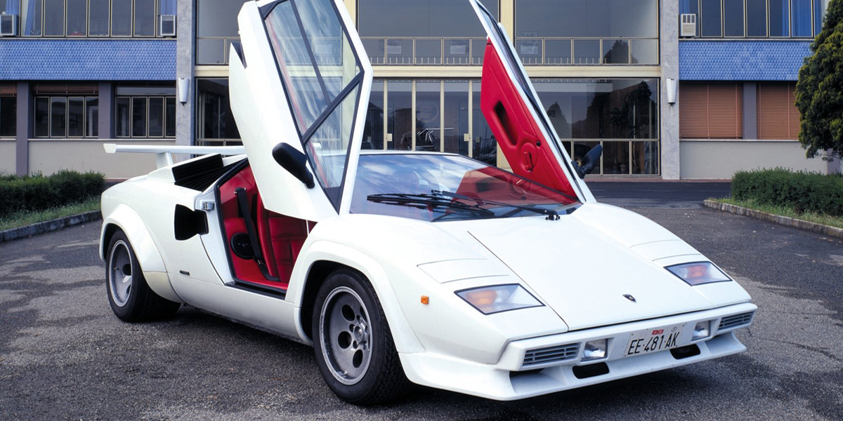 A white Lamborghini Countach LP500 S with its doors up