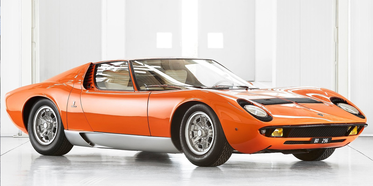 An orange Lamborghini Miura P400 in a warehouse