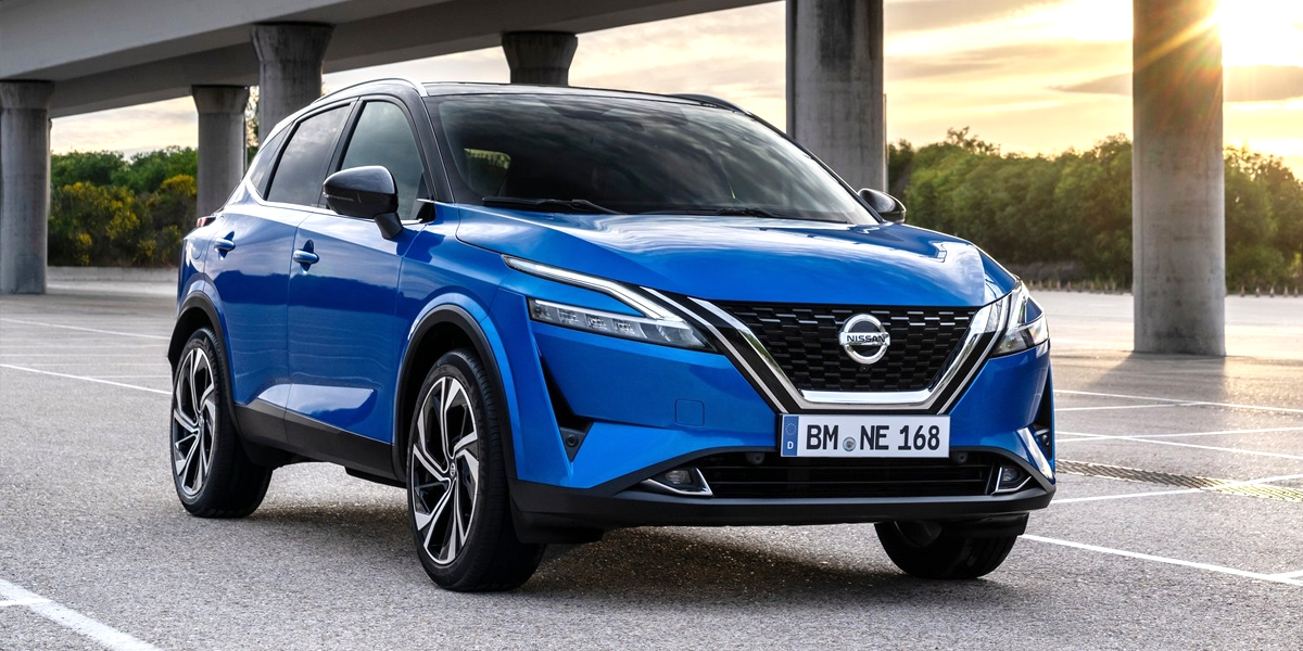 A Nissan Qashqai parked in a car park under a highway