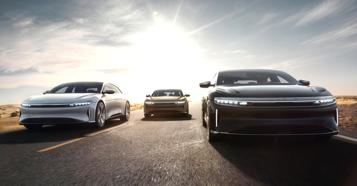 Three Lucid Airs driving down a road