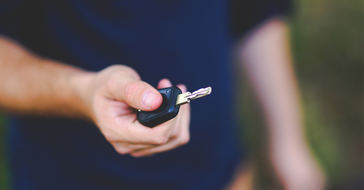 A person holding a car key fob
