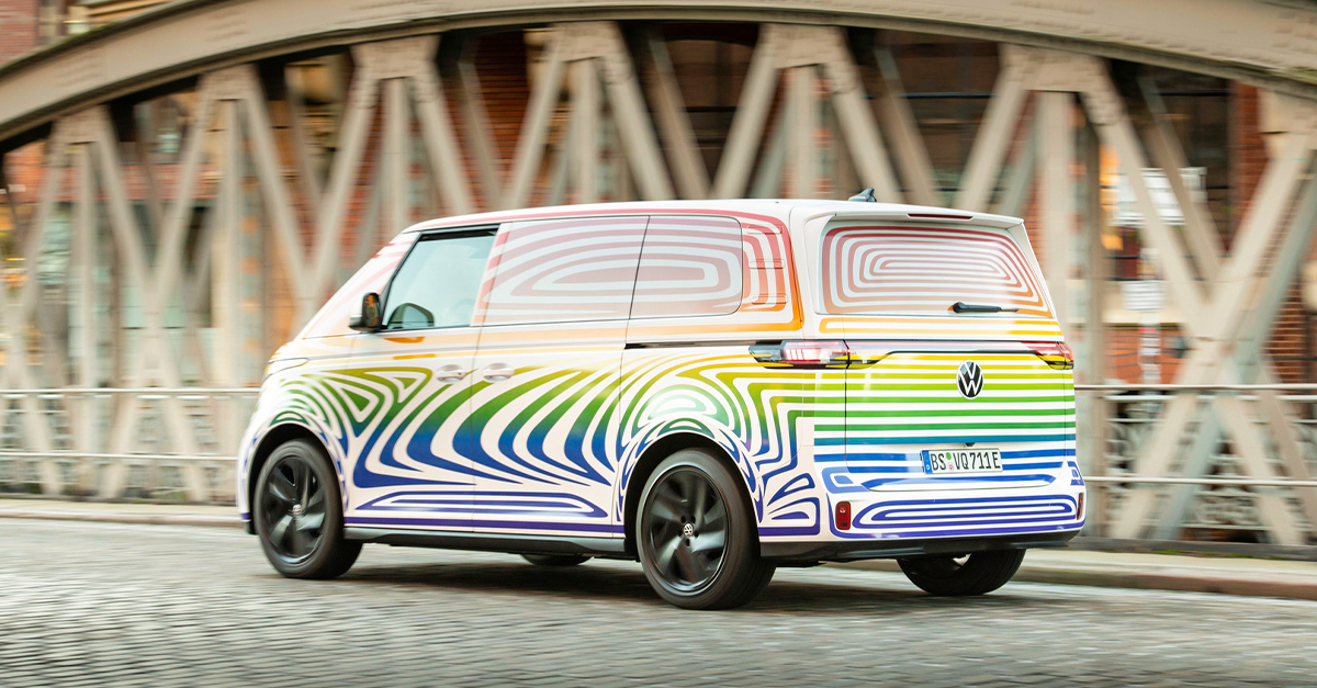 Volkswagen ID.Buzz in a colourful wrap driving down a cobbled road