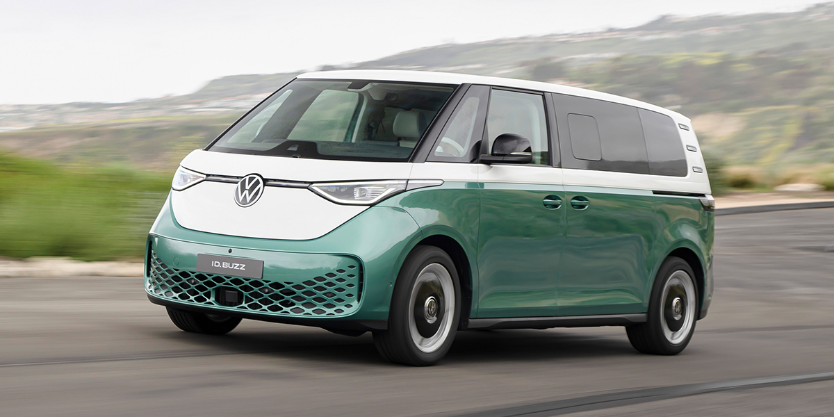 A Volkswagen ID.Buzz driving down a road at speed