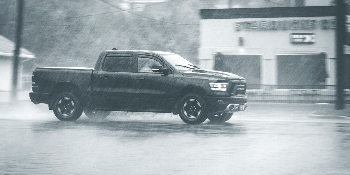 A pickup truck driving in rain