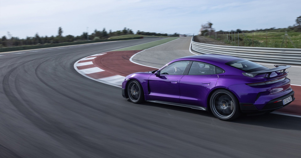 Purple Porsche Taycan racing on a track