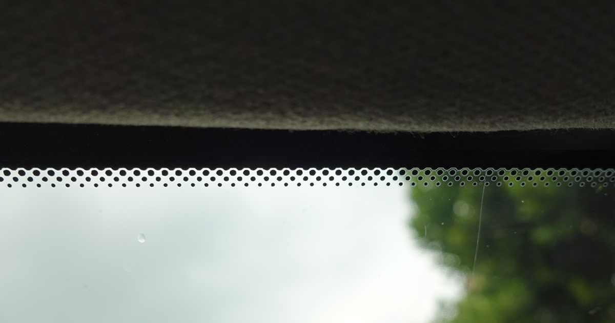 Close-up of the black dots on a car window