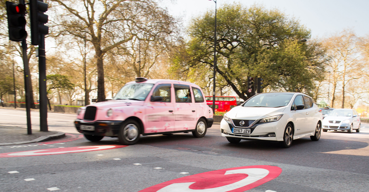A taxi and car entering a Congestion Charge zone