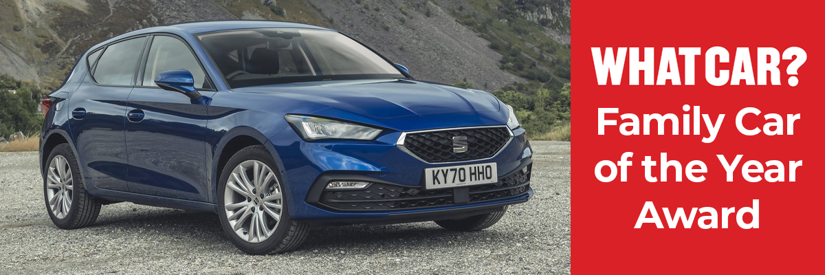 A SEAT Leon parked in front of a hillside