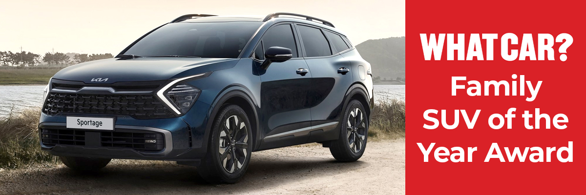 A Kia Sportage parked next to a lake