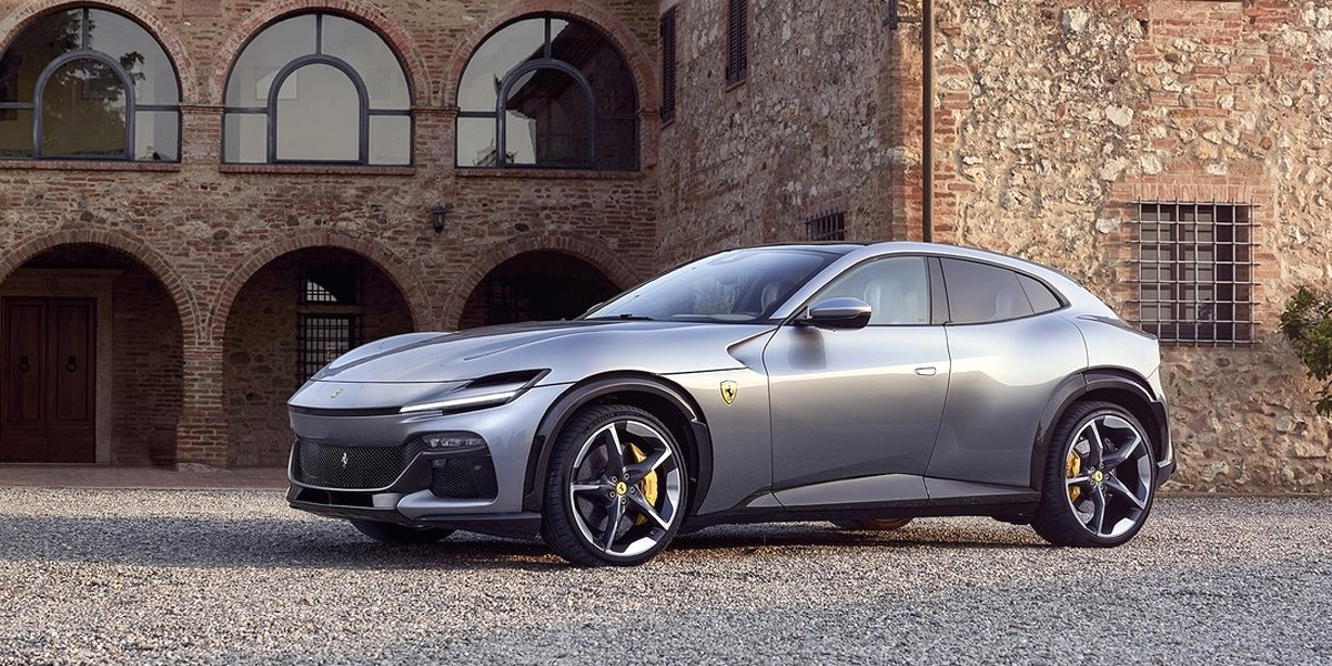 A Ferrari Purosangue parked in front of a brick building