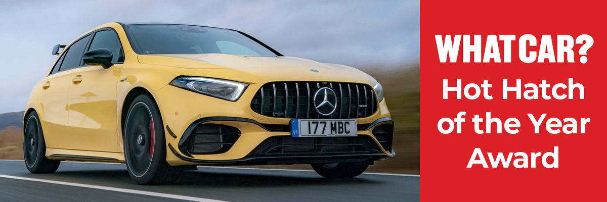 A yellow Mercedes-Benz AMG A45 S in yellow driving down a road