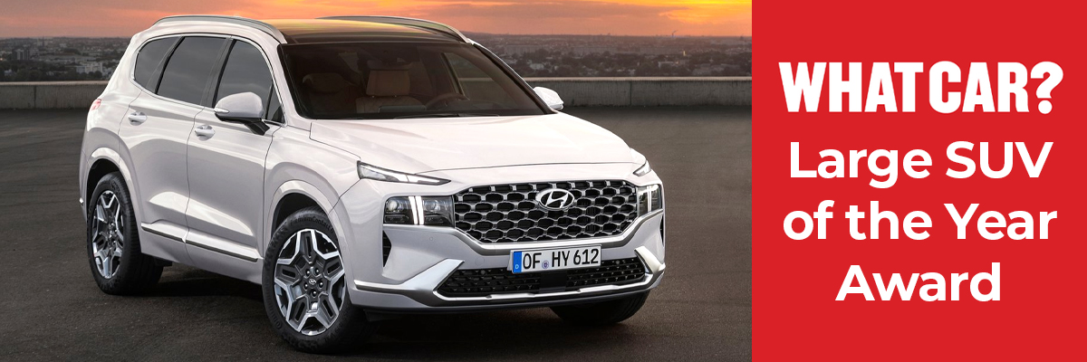 A white Hyundai Santa Fe parked
