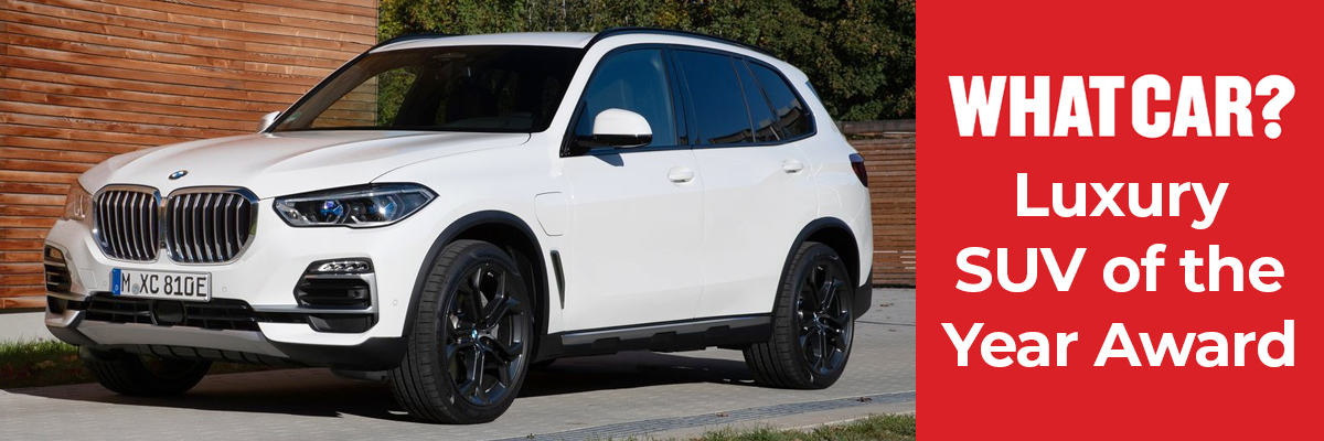 A white BMW X5 parked on a driveway