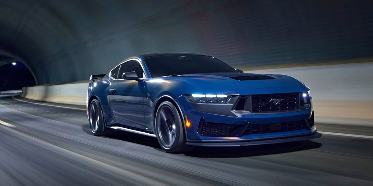 A blue Ford Mustang driving inside a tunnel