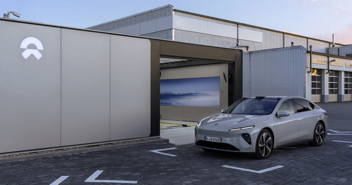 Nio electric car next to a battery swap station