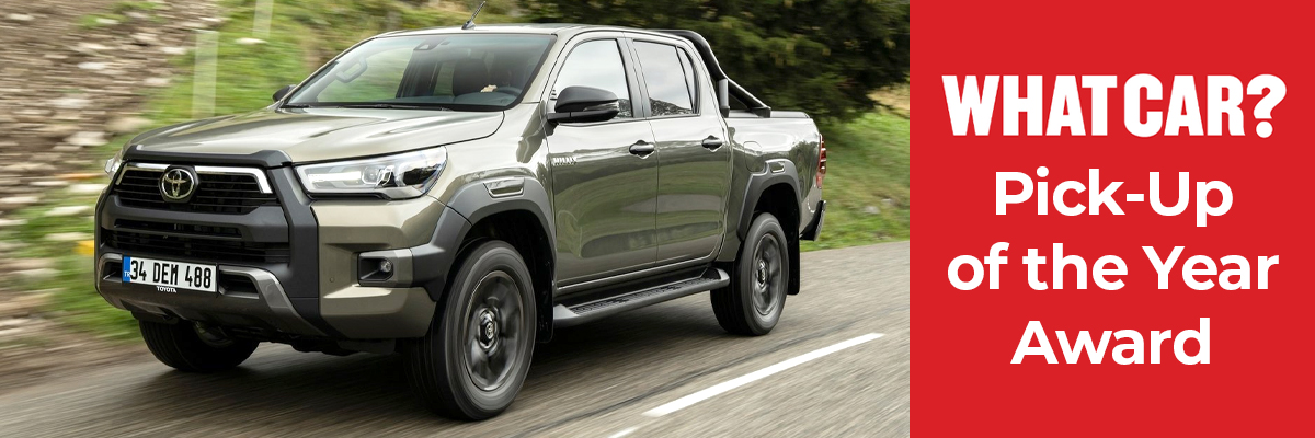 A Toyota Hilux driving down a road