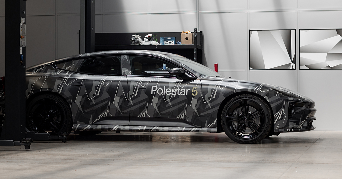 Polestar 5 prototype in camo paint parked in a garage