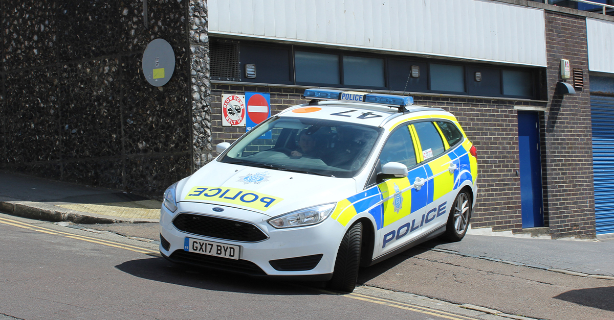 A British police car turning out of a driveway