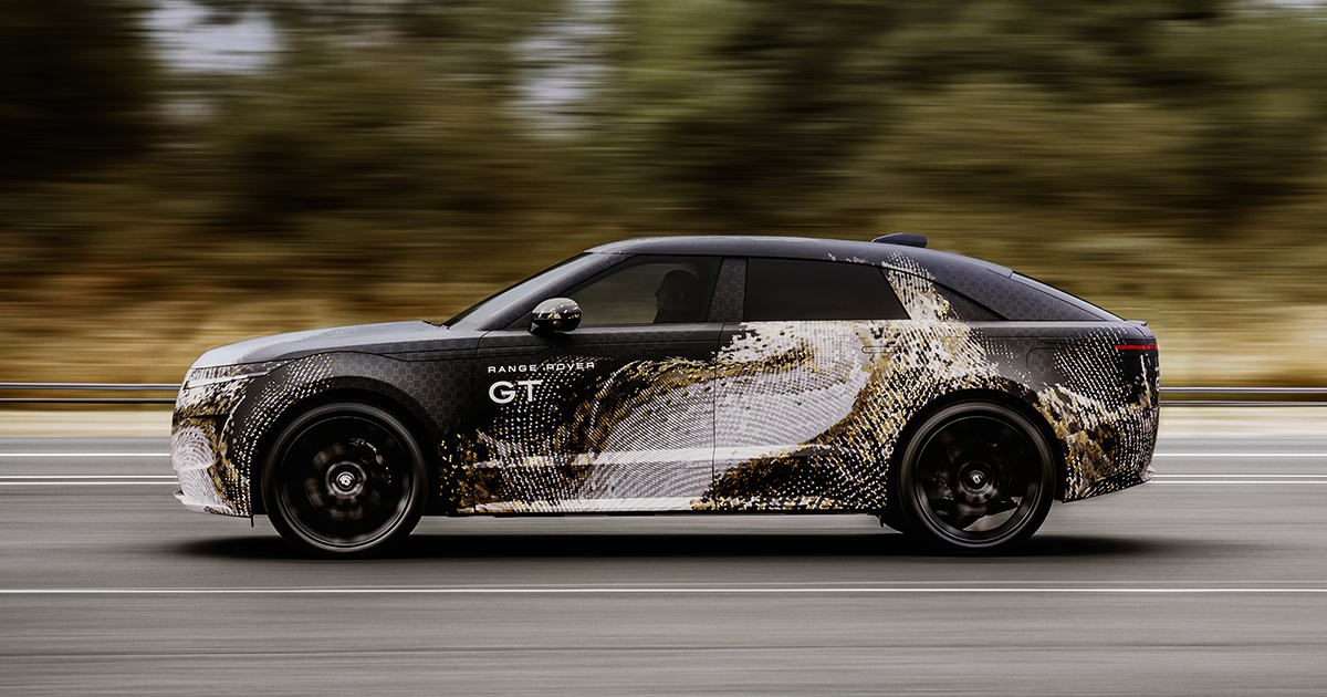 Side angle of a camouflaged Range Rover GT driving