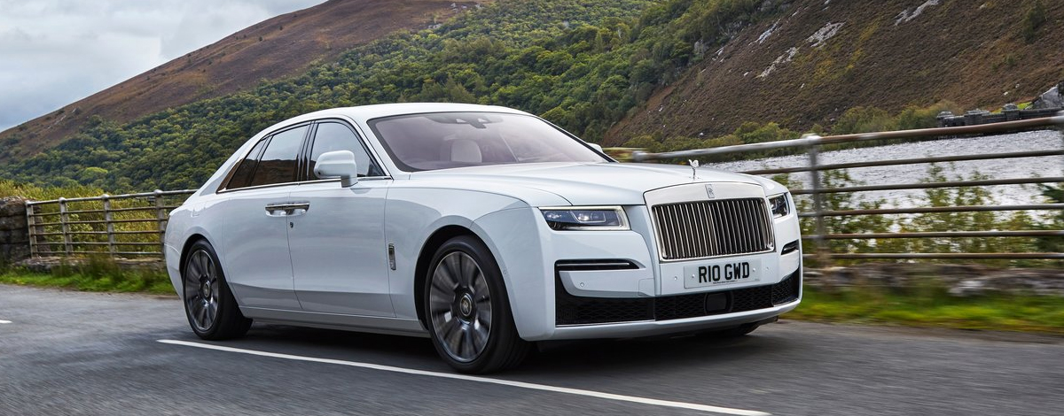 A Rolls-Royce driving down a country road