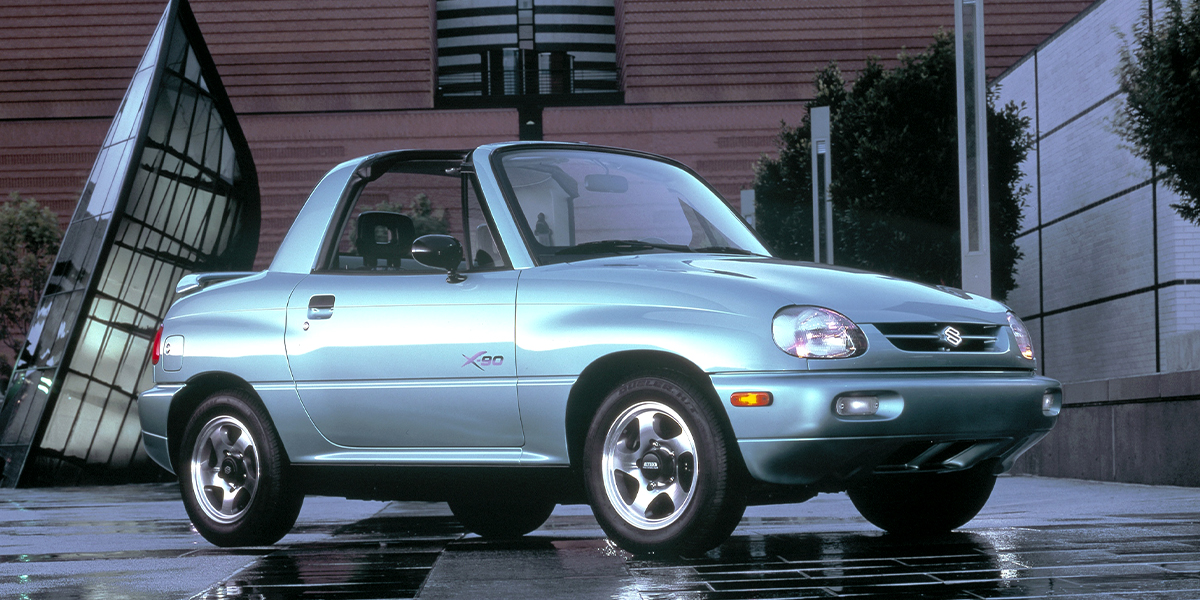 A Suzuki X90 parked in front of a building
