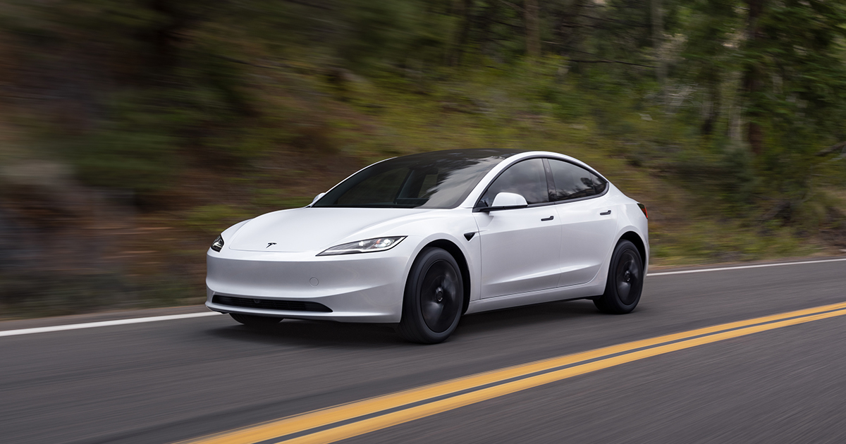 Front angle of a white Tesla Model 3 Standard driving