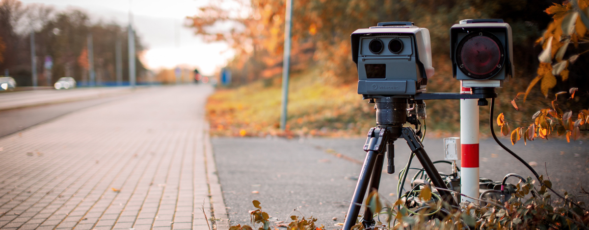 A speed camera next to a road