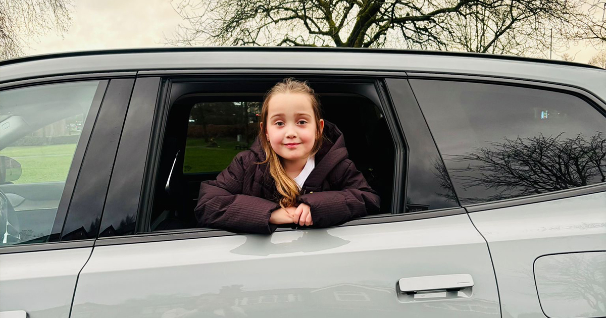 Child looking out of the window of a Volvo EX90