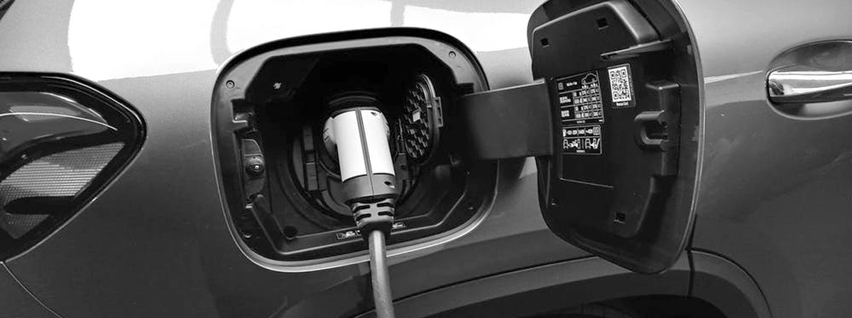 A charger plugged into an electric car