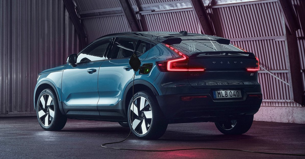 Rear view of a Volvo C40 Recharge being charged in a hangar