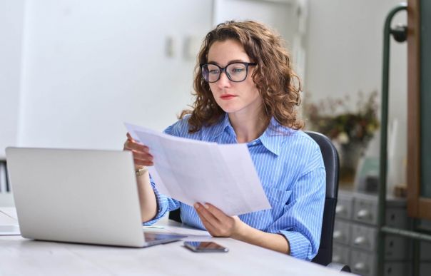 A person sat at their desk reading about their company’s salary sacrifice scheme.